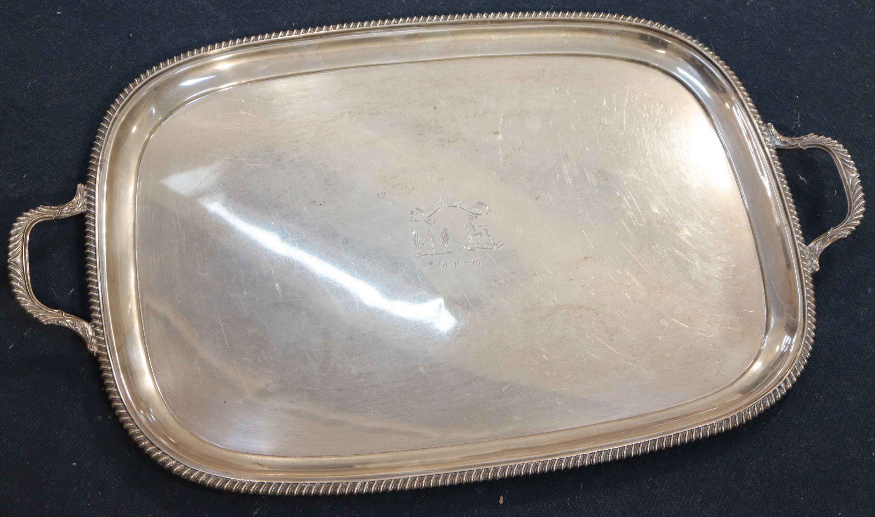 A George V silver two handled tea tray, 64.7cm over handles, 98oz.